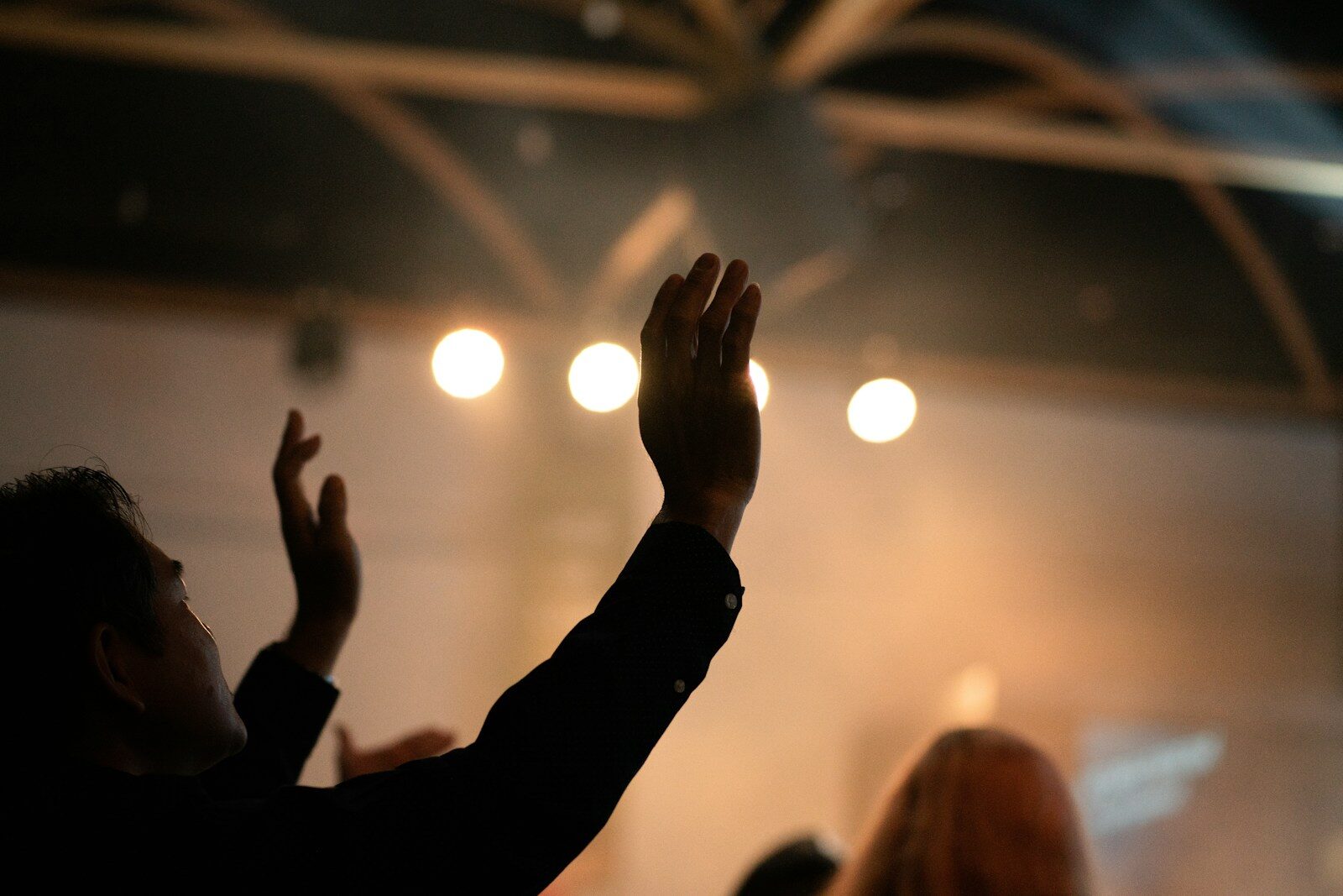 Person with hands raised in worship