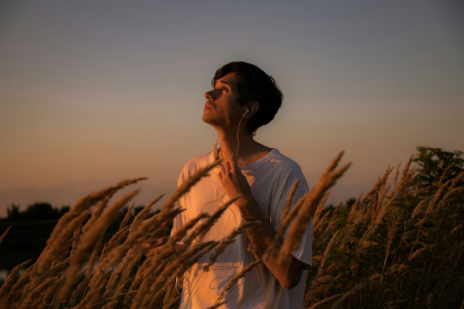 a man standing in a field of tall grass